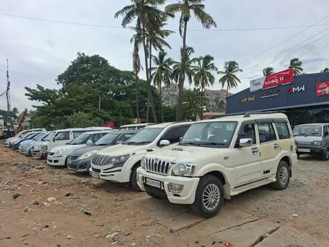 A line of larger vehicles including a Scorpio and several SUVs on the forecourt.